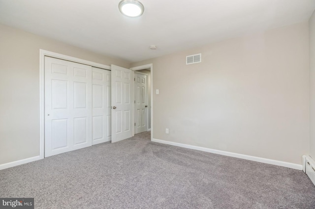 unfurnished bedroom featuring a closet, visible vents, baseboards, and carpet