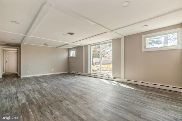 interior space featuring visible vents, baseboards, and wood finished floors