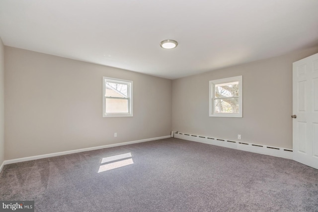 carpeted spare room featuring a baseboard radiator and baseboards