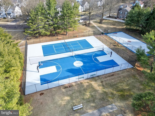 view of basketball court featuring community basketball court, fence, and a tennis court