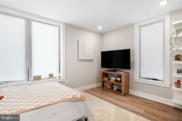 bedroom with recessed lighting, baseboards, and wood finished floors