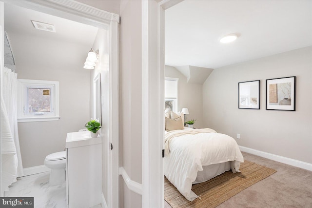 bedroom with lofted ceiling, baseboards, visible vents, and marble finish floor