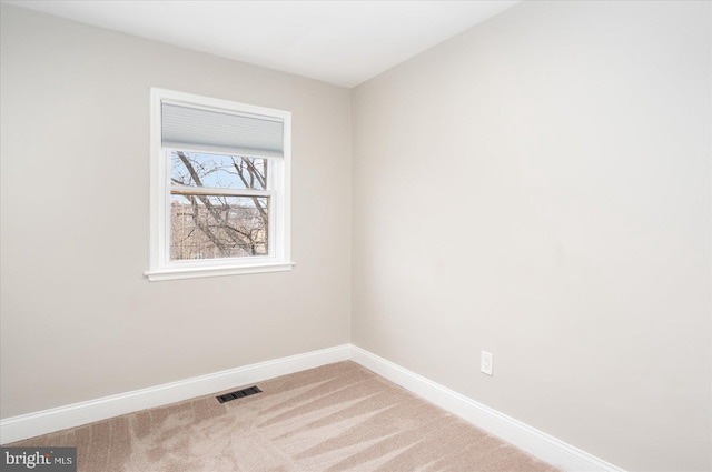 unfurnished room featuring visible vents, baseboards, and carpet