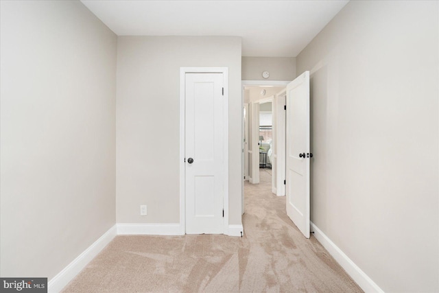 unfurnished bedroom with carpet flooring and baseboards