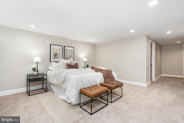 bedroom featuring recessed lighting, light colored carpet, and baseboards