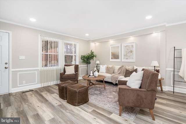 living area featuring recessed lighting, visible vents, ornamental molding, and wood finished floors