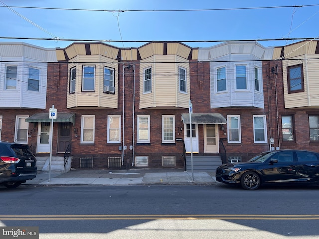 multi unit property featuring entry steps and brick siding