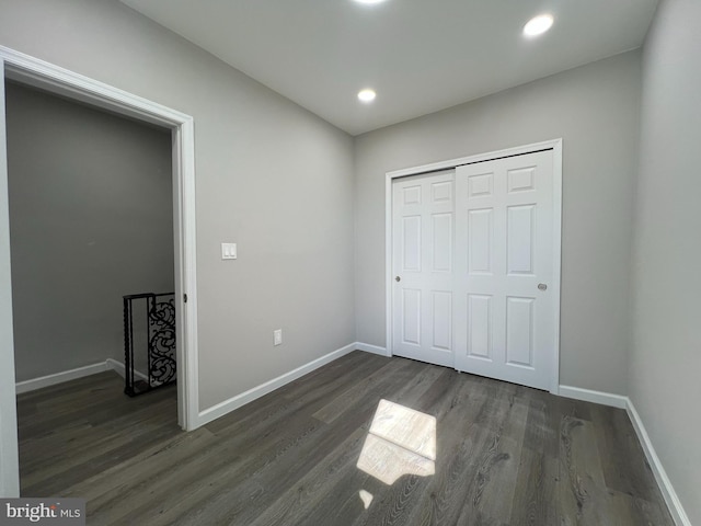 unfurnished bedroom with dark wood finished floors, recessed lighting, and baseboards