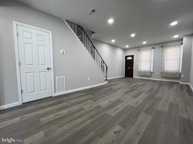 interior space featuring recessed lighting, visible vents, dark wood finished floors, and stairway