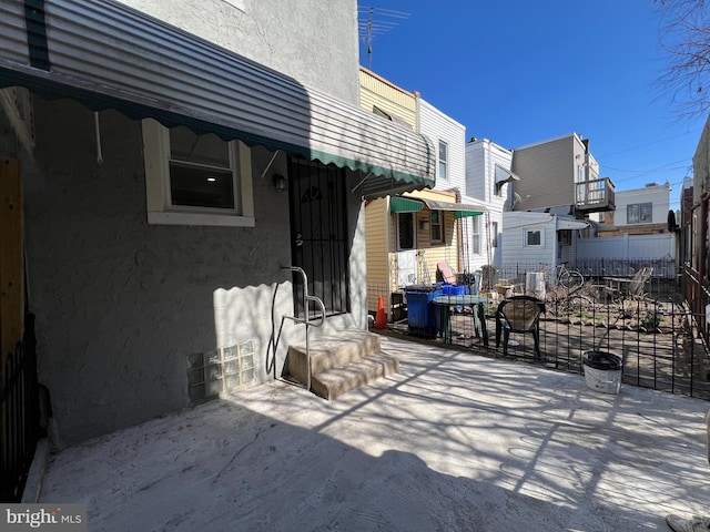 view of patio featuring fence