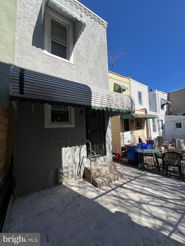 back of property featuring stucco siding and a patio