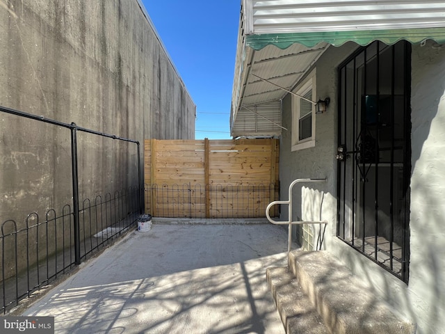 view of patio featuring fence