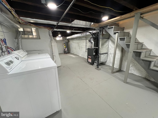 below grade area with stairs, water heater, and washing machine and clothes dryer