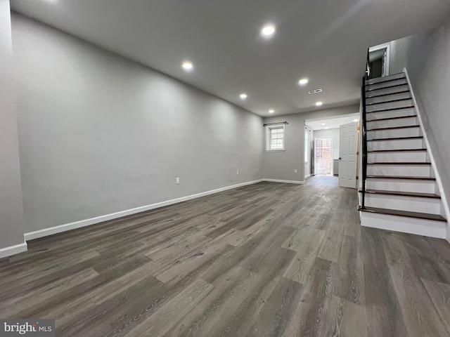 unfurnished living room featuring visible vents, baseboards, stairs, recessed lighting, and wood finished floors