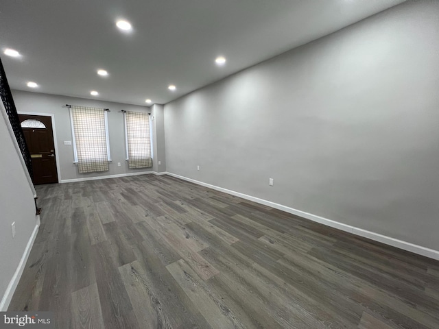 unfurnished living room featuring recessed lighting, baseboards, and wood finished floors