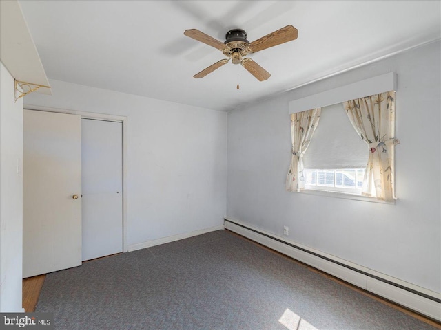 unfurnished room with a ceiling fan and a baseboard radiator