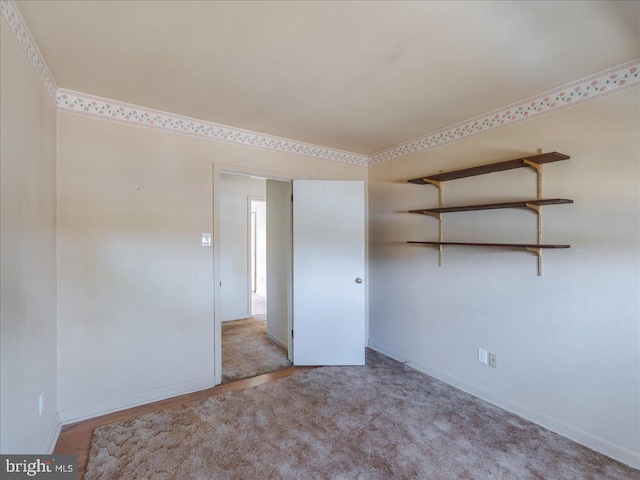 carpeted spare room with baseboards