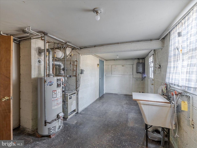 below grade area featuring concrete block wall and water heater