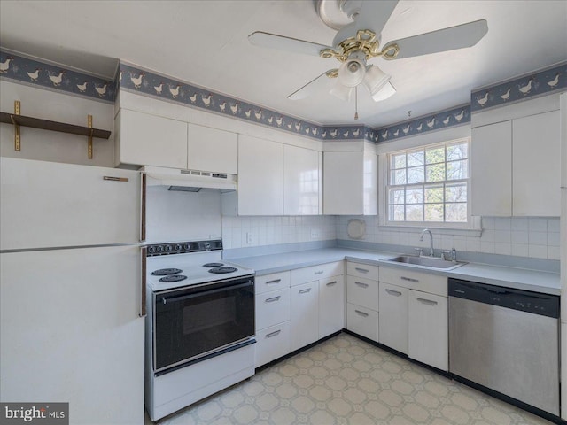 kitchen featuring electric stove, a sink, under cabinet range hood, freestanding refrigerator, and dishwasher