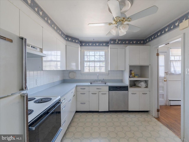 kitchen with electric range, under cabinet range hood, a sink, baseboard heating, and dishwasher