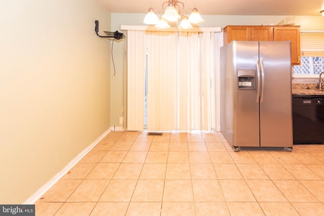 kitchen with baseboards, dishwasher, light tile patterned floors, stainless steel refrigerator with ice dispenser, and a notable chandelier