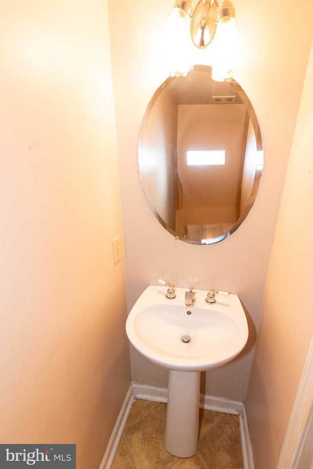 bathroom featuring tile patterned flooring and baseboards