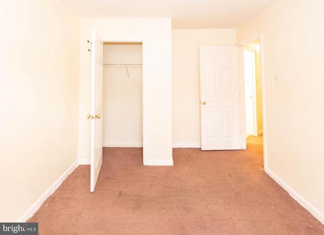 unfurnished bedroom featuring baseboards and carpet