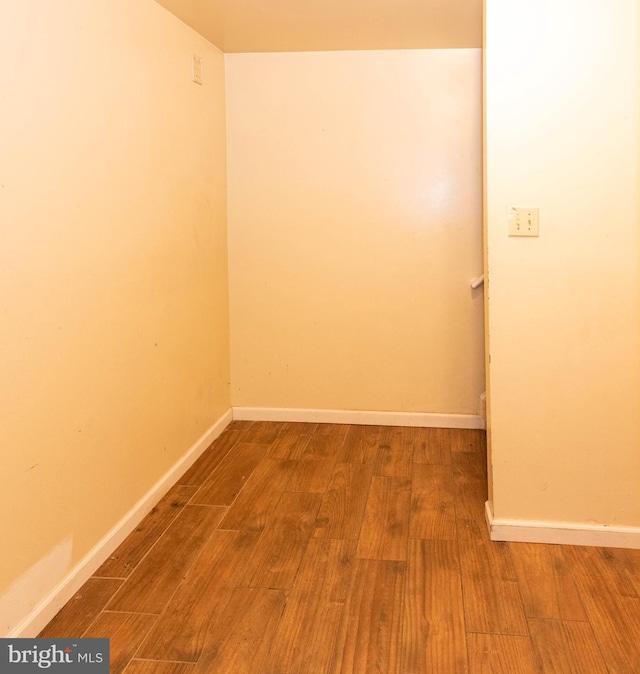 empty room featuring baseboards and wood finished floors