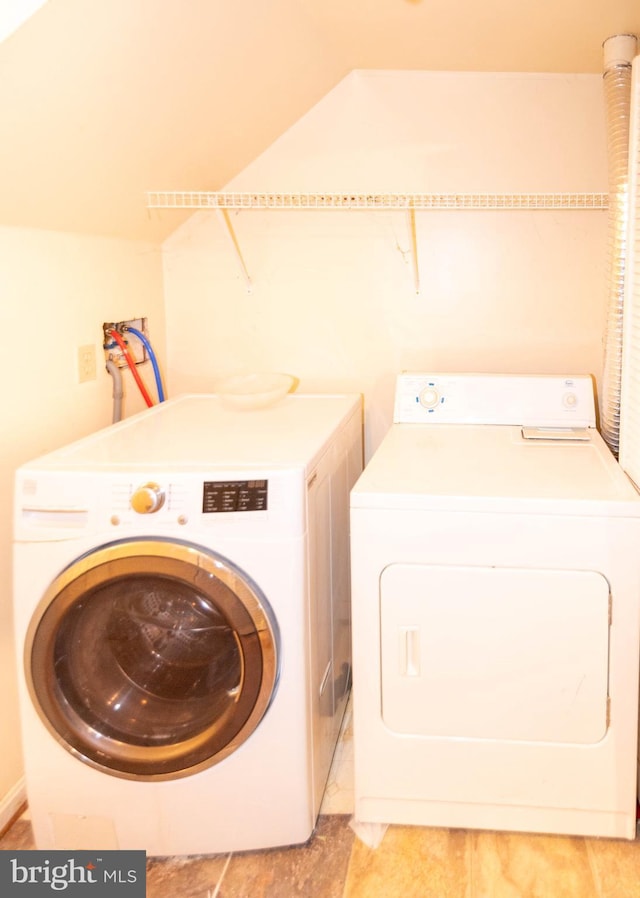 washroom featuring laundry area and washing machine and dryer