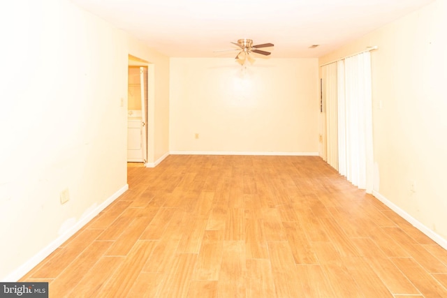 unfurnished room featuring a ceiling fan, light wood-style floors, and baseboards