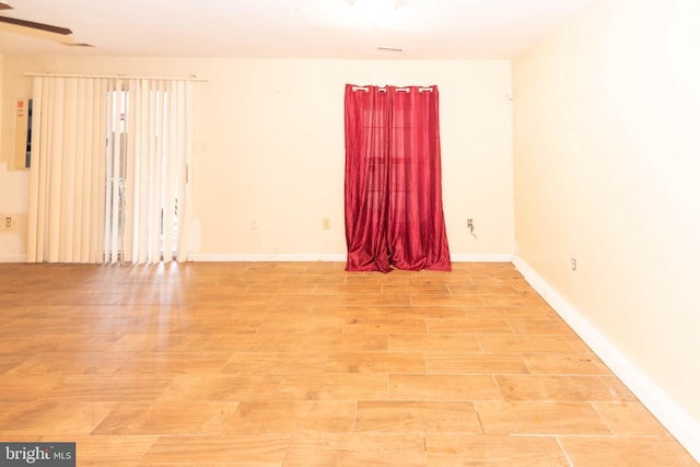 empty room with light wood-style floors and baseboards