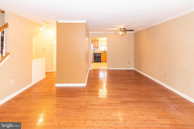 unfurnished living room featuring light wood-type flooring, ornamental molding, a ceiling fan, stairway, and baseboards