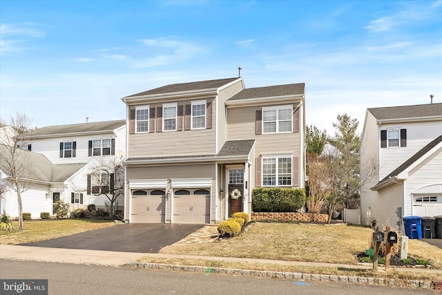 traditional-style home featuring aphalt driveway, an attached garage, roof with shingles, and a front lawn