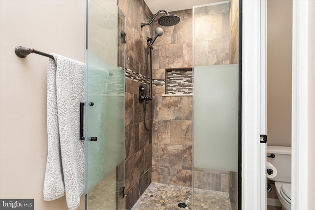 full bathroom with a shower stall and toilet