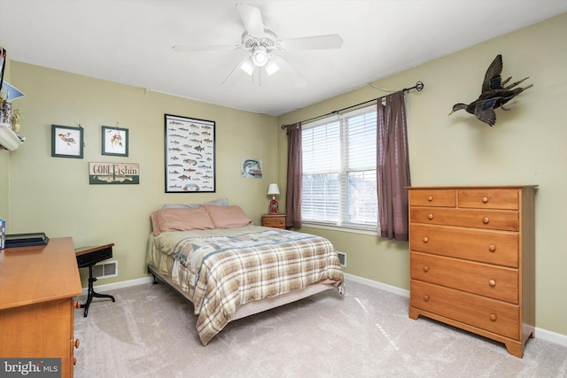 bedroom featuring visible vents, light colored carpet, a ceiling fan, and baseboards