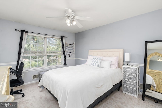 bedroom with carpet flooring, visible vents, baseboards, and ceiling fan