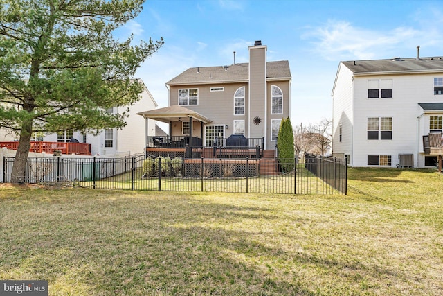 back of property with fence, a wooden deck, central AC, a chimney, and a lawn