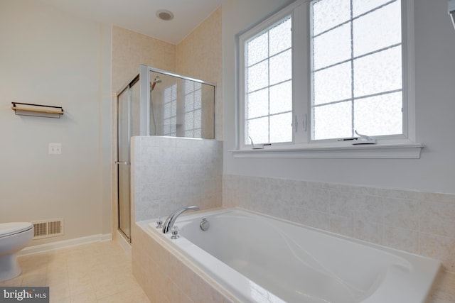 bathroom with toilet, a stall shower, a garden tub, and visible vents