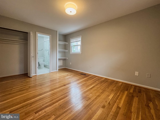 unfurnished bedroom featuring light wood-style floors, visible vents, and baseboards