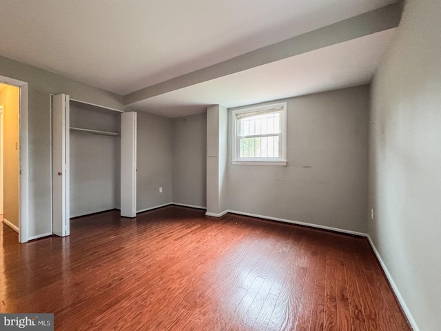 unfurnished bedroom featuring baseboards and wood finished floors