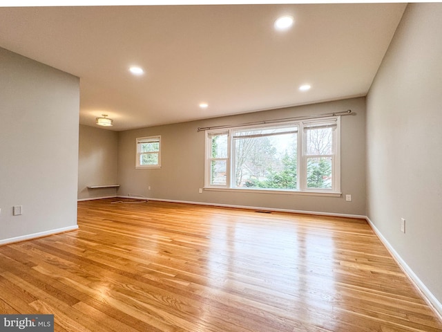 empty room with visible vents, recessed lighting, baseboards, and light wood-style floors