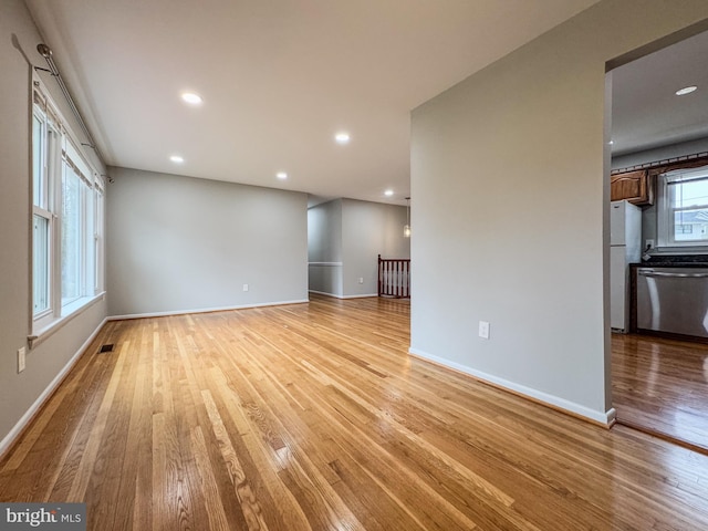 unfurnished living room featuring recessed lighting, visible vents, baseboards, and light wood finished floors