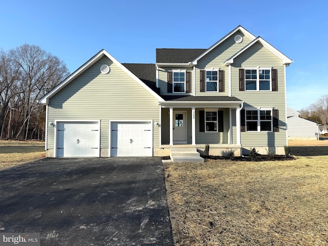 view of front of house featuring aphalt driveway, a garage, covered porch, and a shingled roof