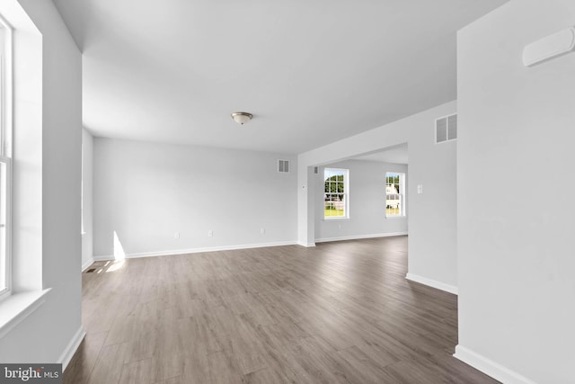 interior space with visible vents, baseboards, and wood finished floors