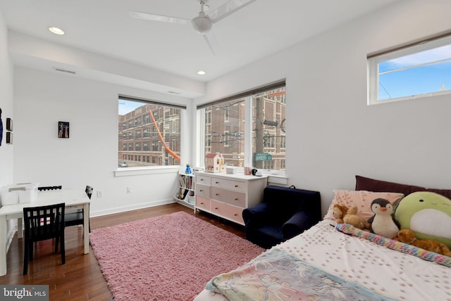 bedroom with recessed lighting, visible vents, baseboards, and wood finished floors