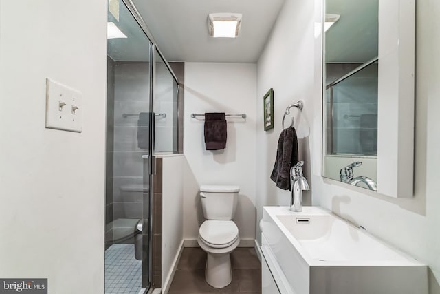 full bathroom with baseboards, vanity, toilet, and a shower stall