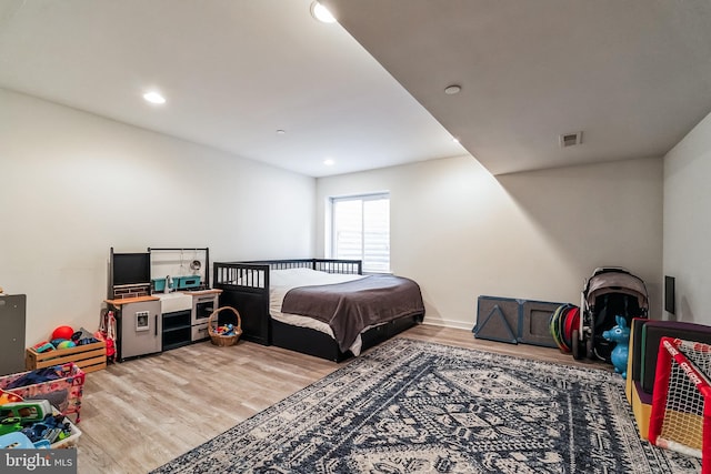 bedroom with recessed lighting, light wood-style floors, and visible vents