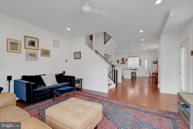 living room with visible vents, recessed lighting, ceiling fan, and wood finished floors