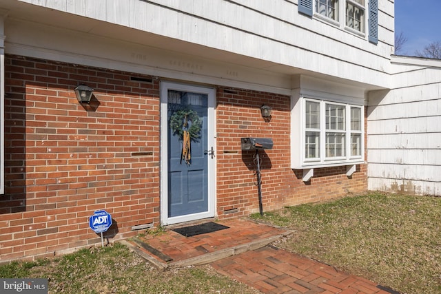 property entrance with brick siding