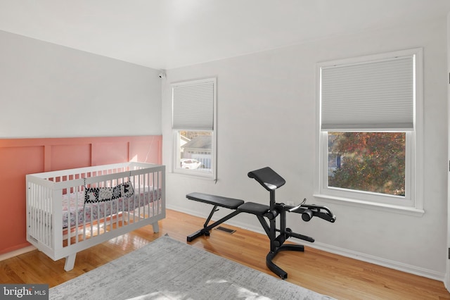 bedroom with baseboards and wood finished floors